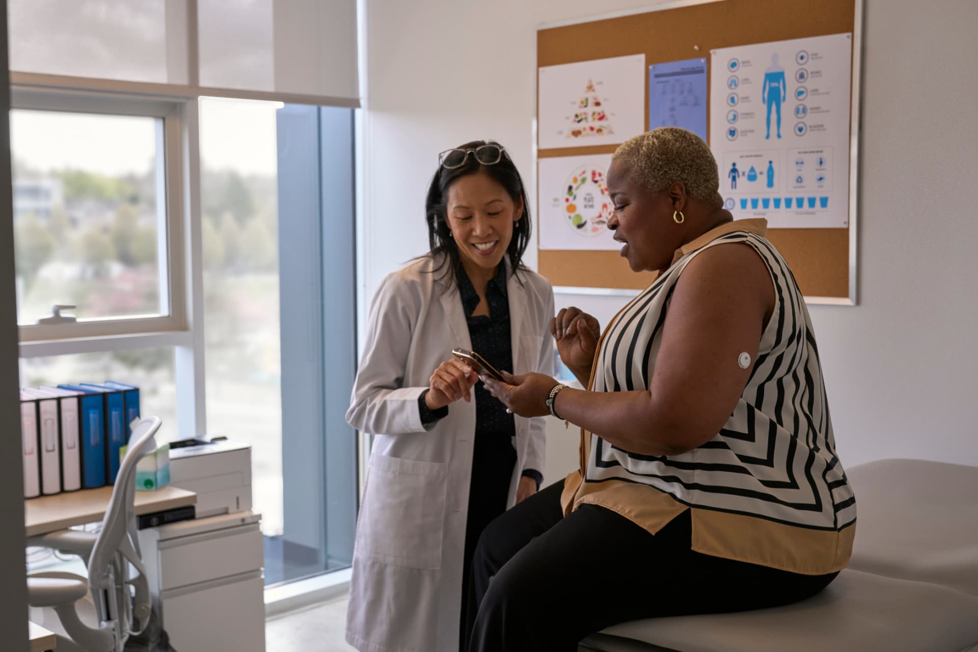 Patient and healthcare professional reviewing glucose information together